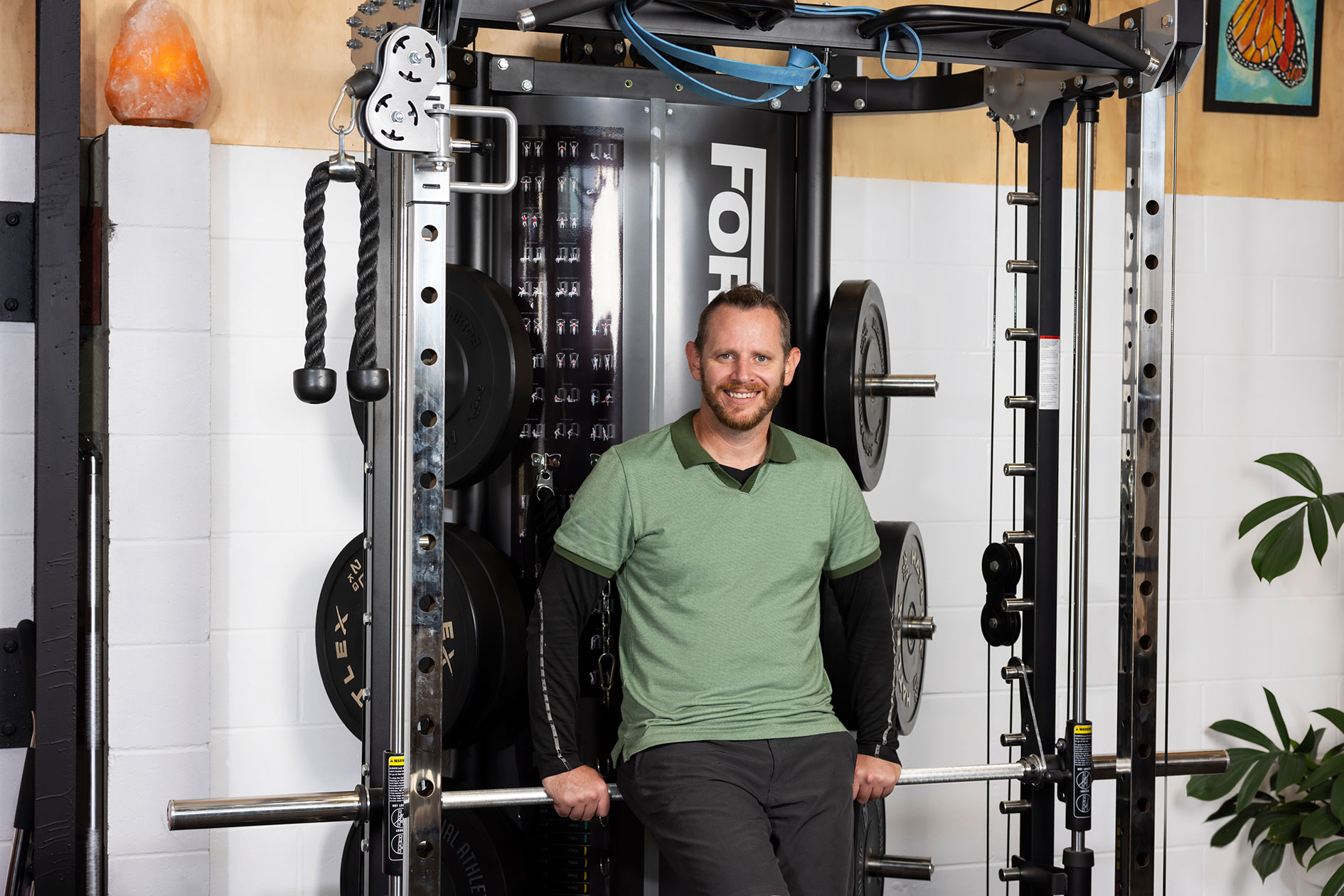 Greg Taylor in front of weight machine.